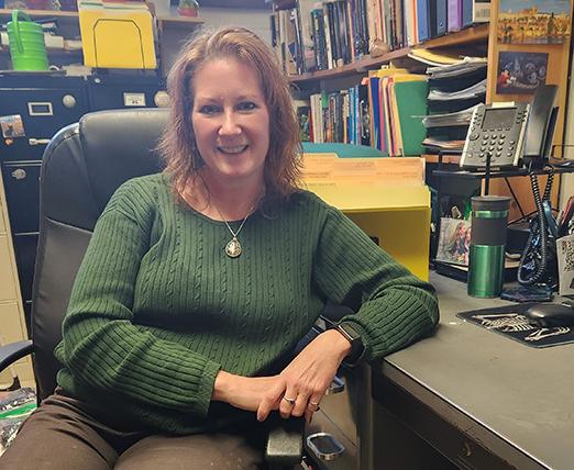 Dani Gagne sitting at her desk.