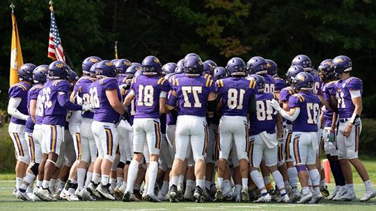 football players in a huddle